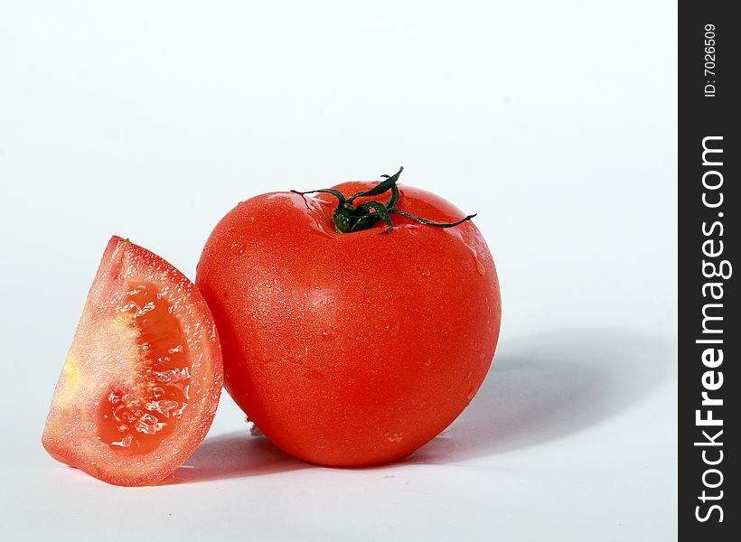 Cut red tomatoes on a white background