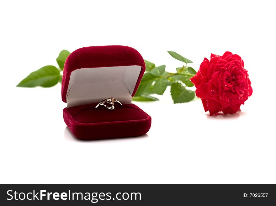 Box with a ring and a scarlet rose. The exciting moment of a life.