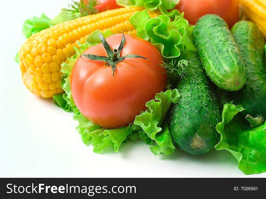 Vegetables: tomatoes, cucumbers and corn. Vivid healthy nutrition.