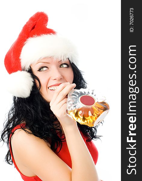 Beautiful smiling brunette woman wearing Santa's hat drinking cognac. Beautiful smiling brunette woman wearing Santa's hat drinking cognac