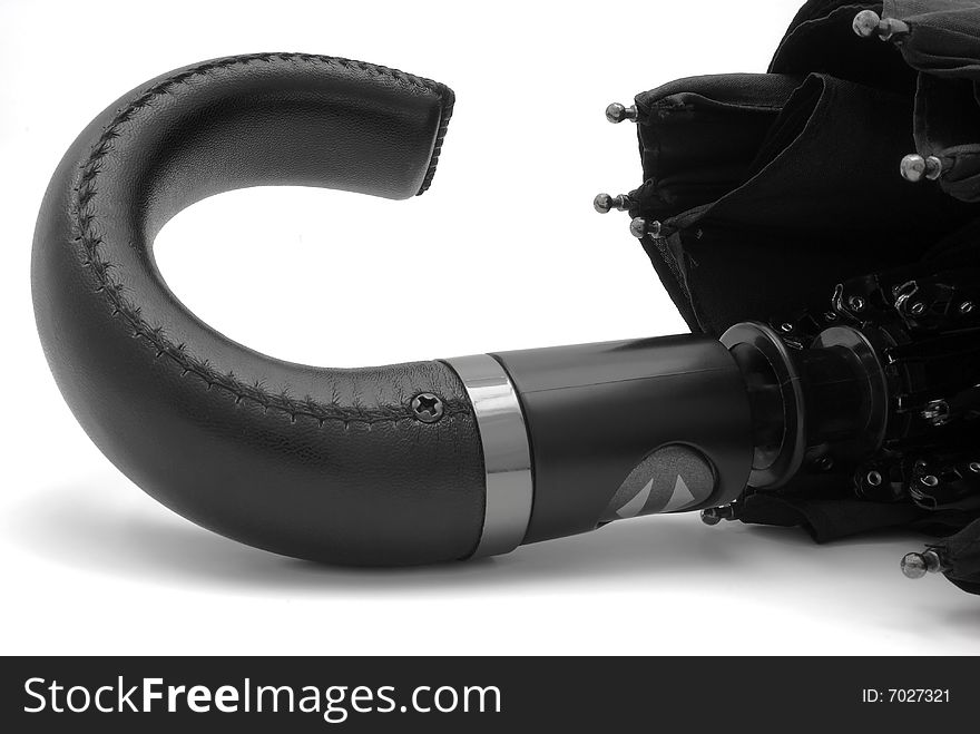 Handle black male umbrella, an object on a white background, close-up. Handle black male umbrella, an object on a white background, close-up.