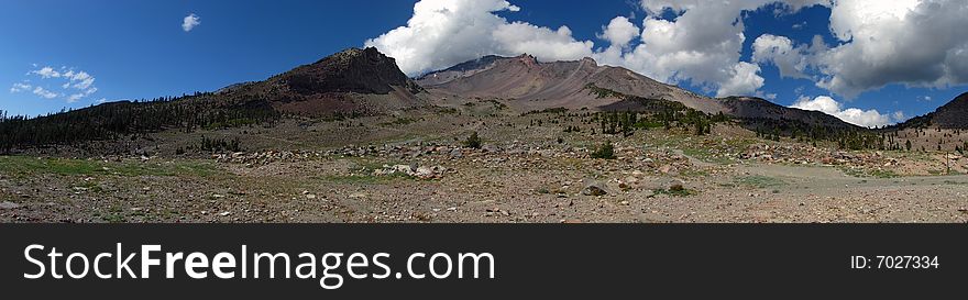 Glacial valley and meadow on southwest face of Mount Shasta in California with partly cloudy sky. Glacial valley and meadow on southwest face of Mount Shasta in California with partly cloudy sky