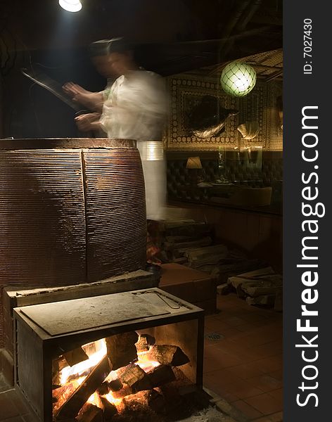 Chef using old world ceramic oven