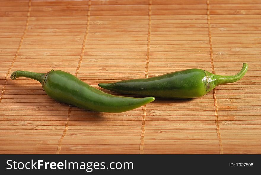 Green chili pepper on wooden background. hot spicy ingredient