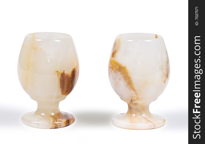 Two glasses from a stone on a white background