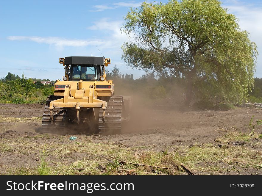 Yellow big bulldozer working in construction site