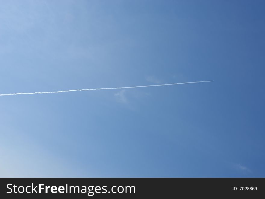 Jet plane in the sky with traces