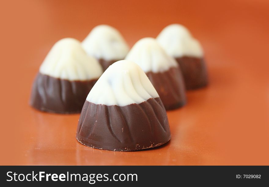 Chocolate candies on a brown background