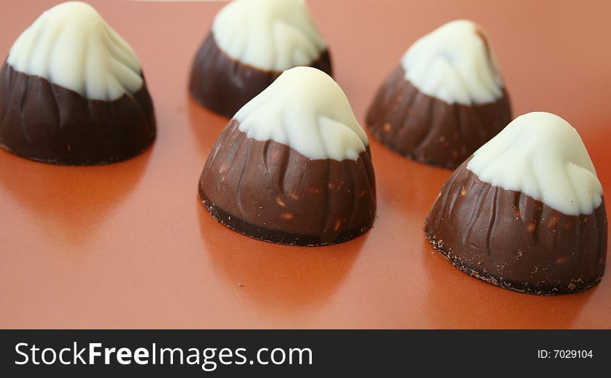 Chocolate candies on a brown background