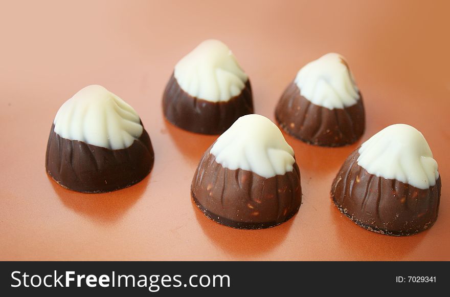 Chocolate candies on a brown background