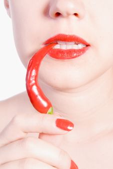 Biting Red Hot Chili Pepper Royalty Free Stock Photos
