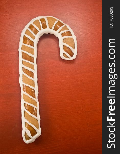 Candy cane cookie on red background. Candy cane cookie on red background