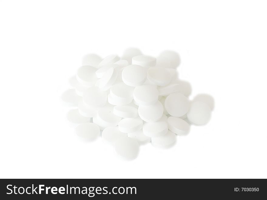 White round vitamins on the white isolated background