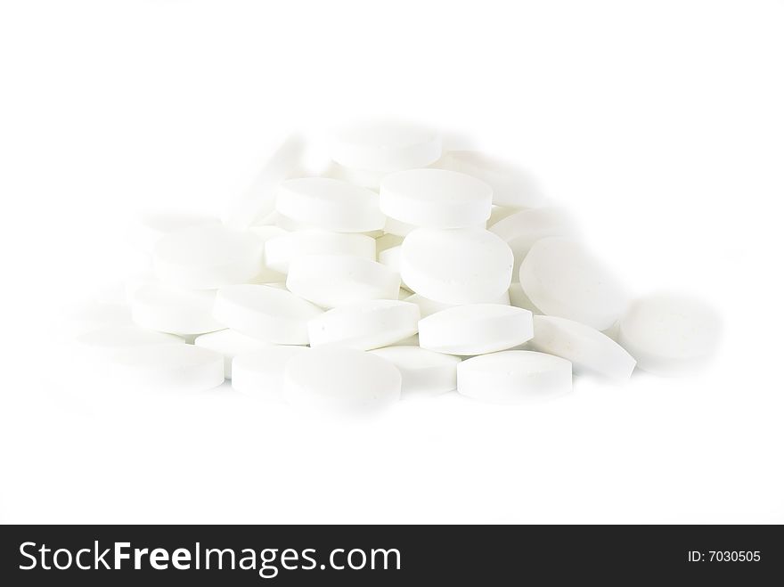 White round vitamins on the white isolated background