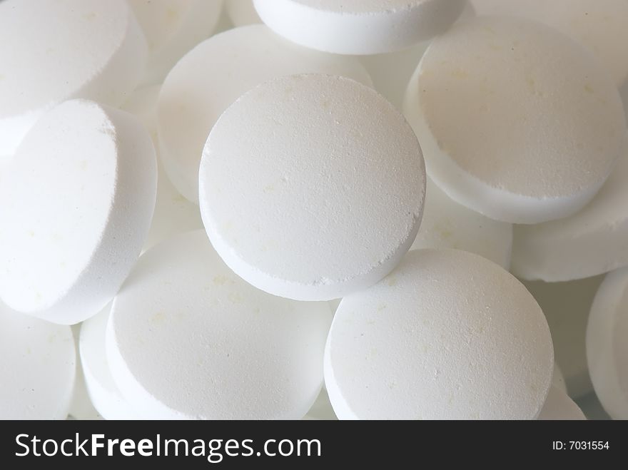 White round vitamins on the white isolated background