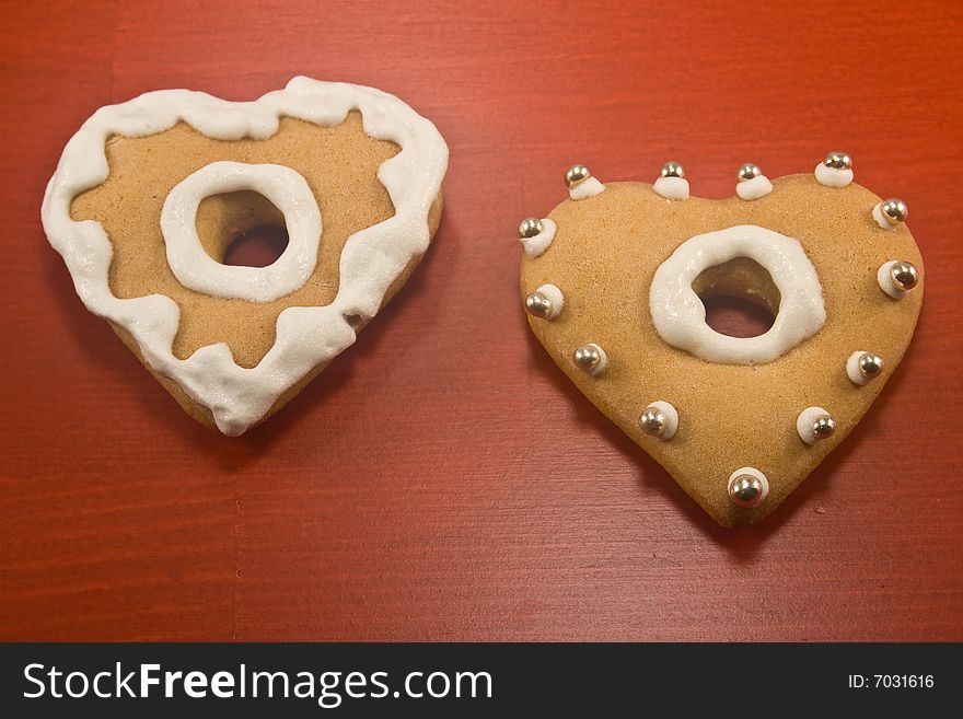 Decorated heart shaped cookies on red background. Decorated heart shaped cookies on red background