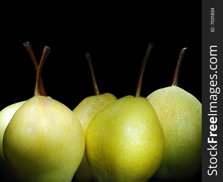 Juicy pears on black background.