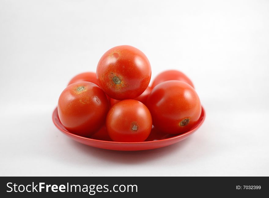 Isolated fresh tomato on a plate