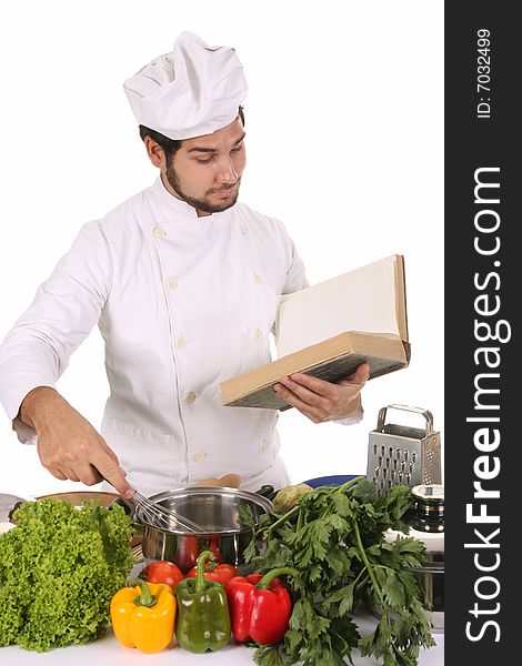 Young chef preparing lunch on white background