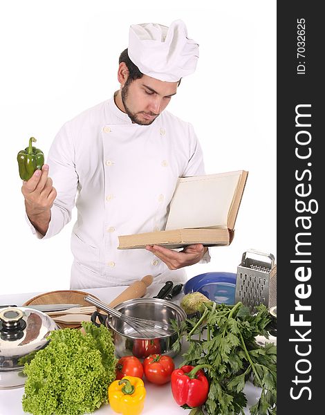 Young chef preparing lunch on white background
