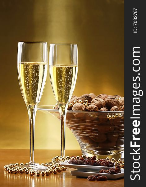 Glasses of champagne with gold background