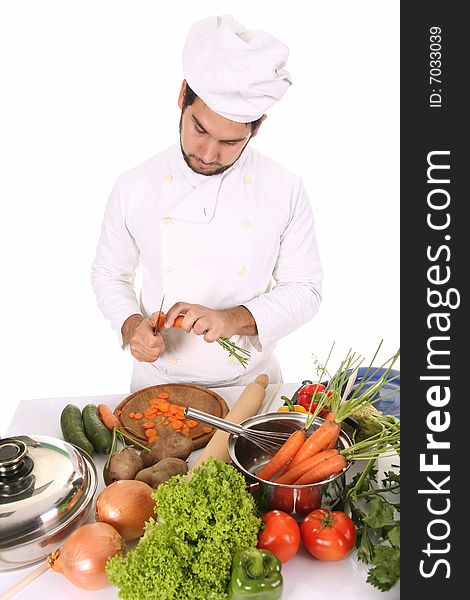 Young chef preparing lunch on white background
