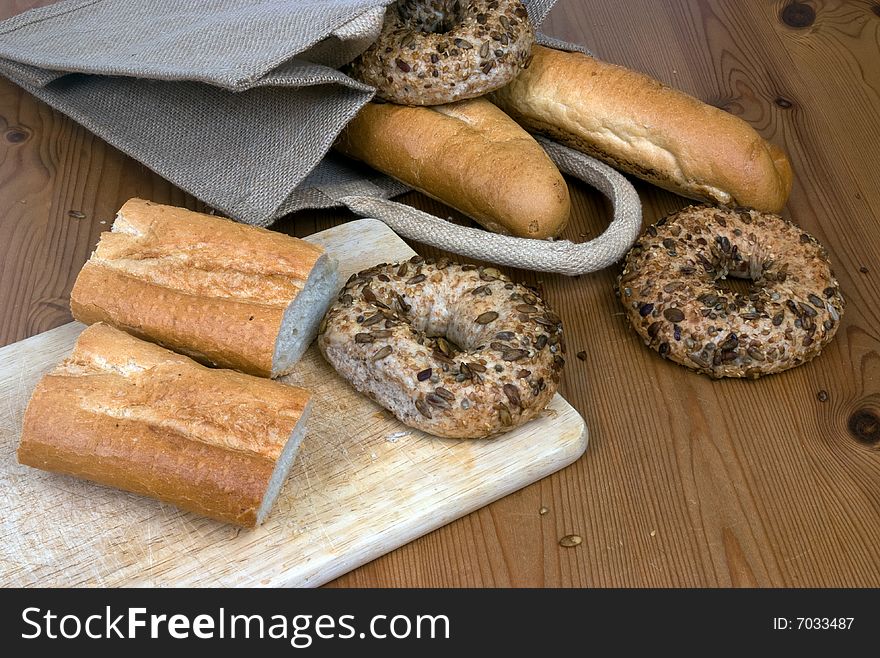 Bagels and French sticks on a kitchen table with a natural shopping bag. Bagels and French sticks on a kitchen table with a natural shopping bag