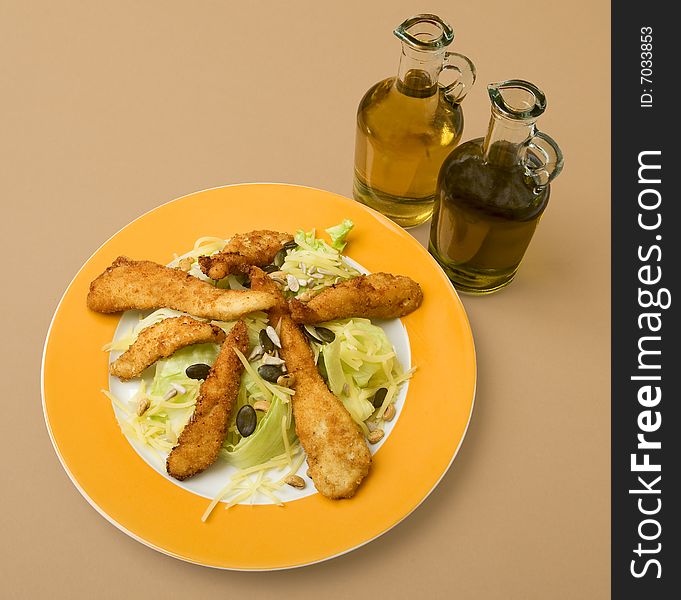 Salad with turkey stripes, on plate for a meal dressed