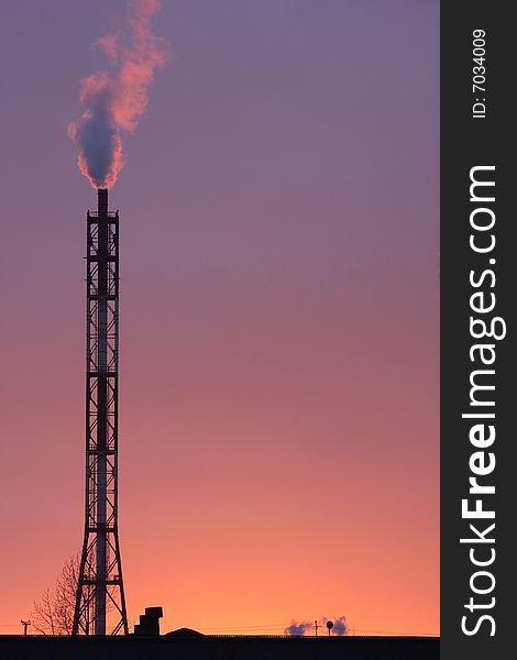 Smoke coming off the industrial stack in the light of sunset. Smoke coming off the industrial stack in the light of sunset.