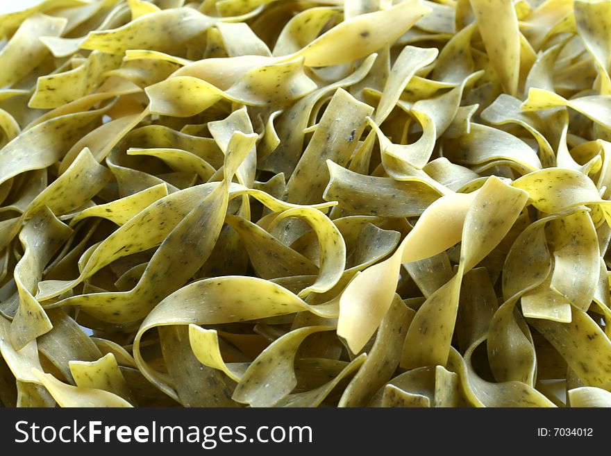 Green noodles with spinach closeup, green backgrond