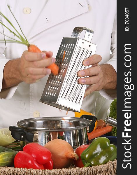 Cutting carrot with stainless grater in motion