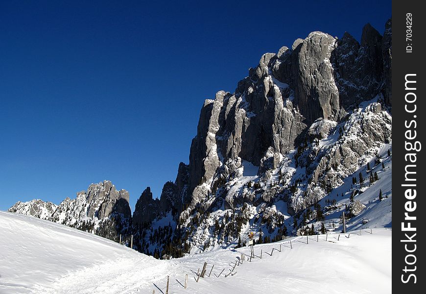 Gastlosen mountain range lies in the pre-Alps near Fribourg area in Switzerland. Although not as high as the mountain ranges in the Alps, Gastlosen presents interesting and steep vertical walls very much appreciated by professional climbers. Image taken from the vicinity of the Chalet du Soldat in winter time (late January). Gastlosen mountain range lies in the pre-Alps near Fribourg area in Switzerland. Although not as high as the mountain ranges in the Alps, Gastlosen presents interesting and steep vertical walls very much appreciated by professional climbers. Image taken from the vicinity of the Chalet du Soldat in winter time (late January).