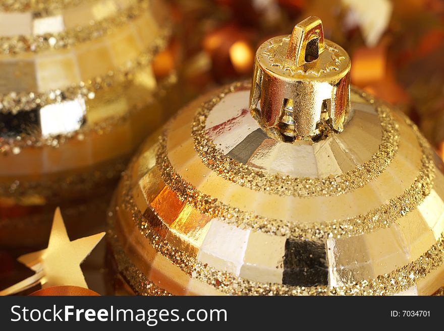 Golden Christmas baubles with golden tinsel. Shallow depth of field