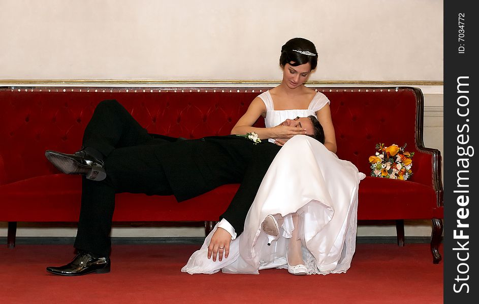 Bride and groom resting on a sofa. Bride and groom resting on a sofa