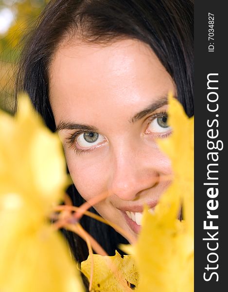 Beautiful Young Woman With Golden Leaves