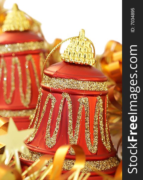 Colorful Christmas bells with golden tinsel on white background. Shallow depth of field