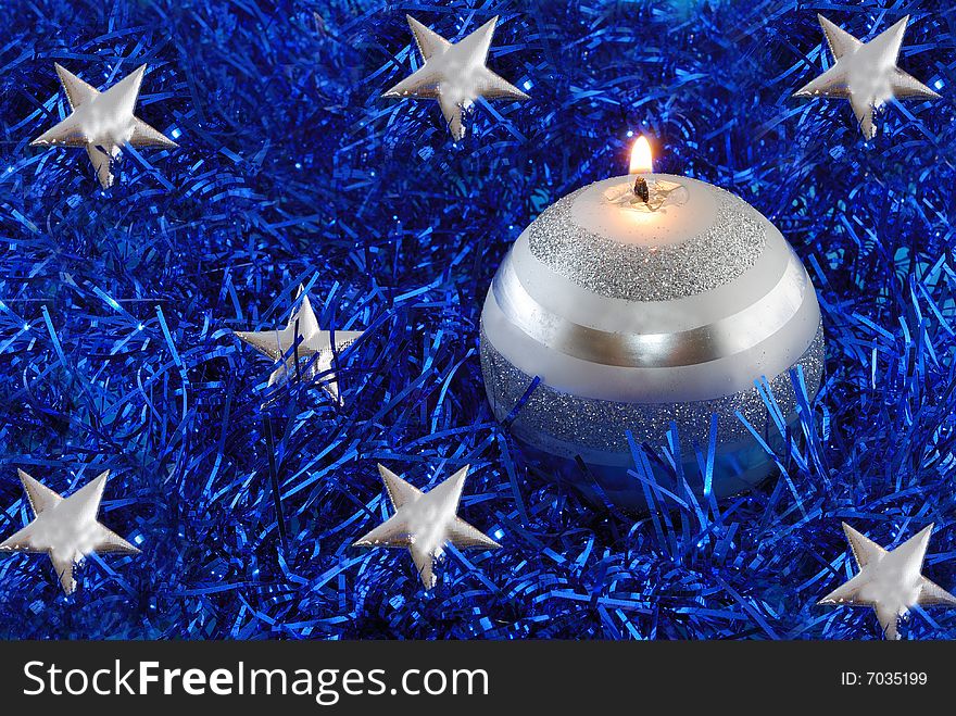 Christmas candle, decorations on tinsel