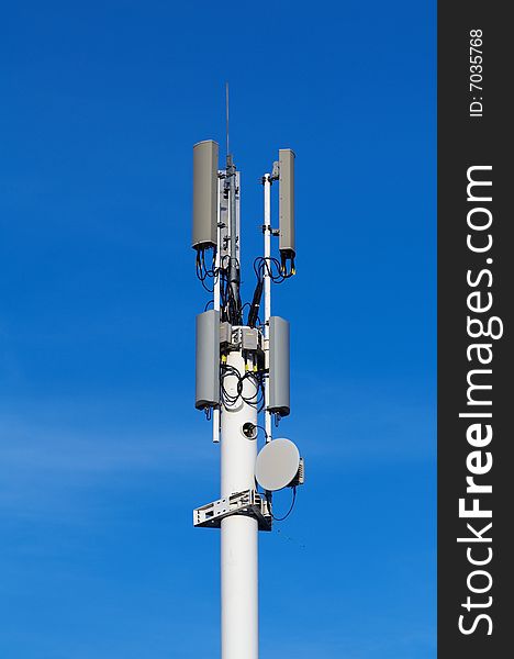 Tower with cellular antennas and sky at the background