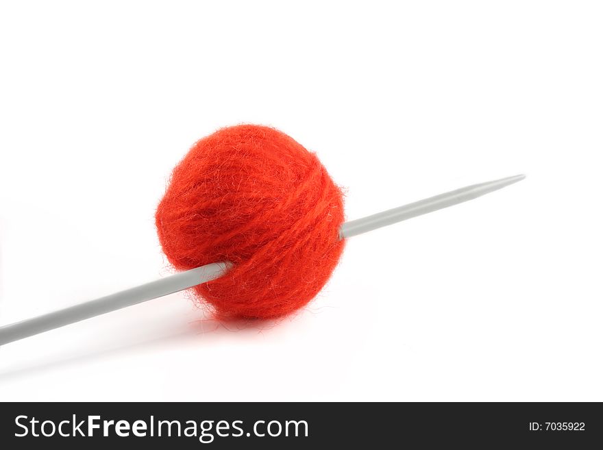 Wool yarn ball on the knitting needle, isolated on a white background. Wool yarn ball on the knitting needle, isolated on a white background