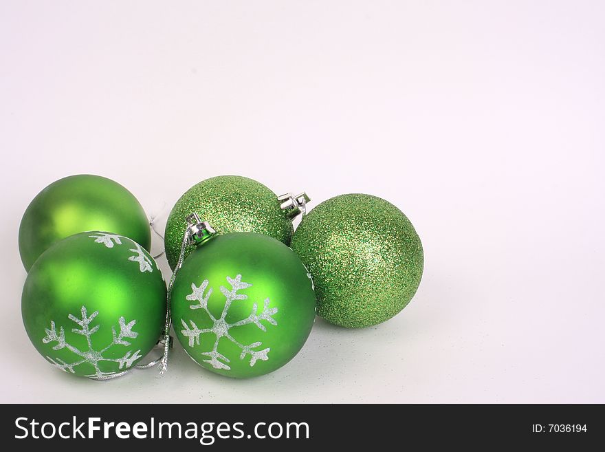 Five green christmas ornaments together. Five green christmas ornaments together