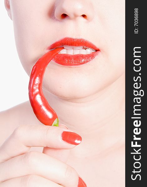 Girl is biting red hot chili pepper