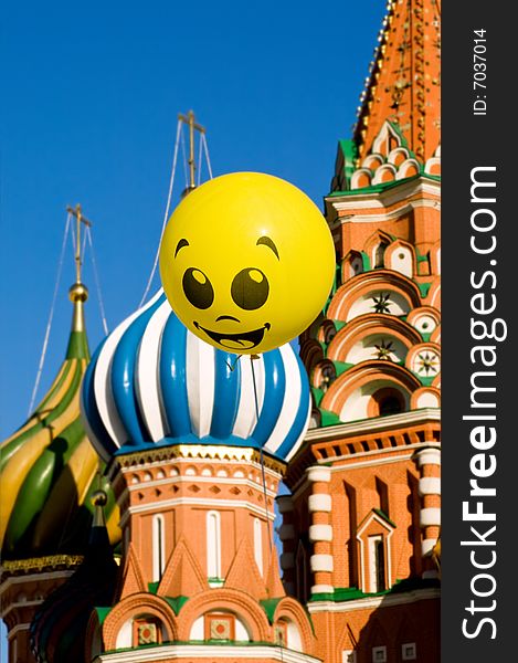 Welcome to Moscow. Yellow happy face balloon against The Saint Basil's Cathedral and blue sky