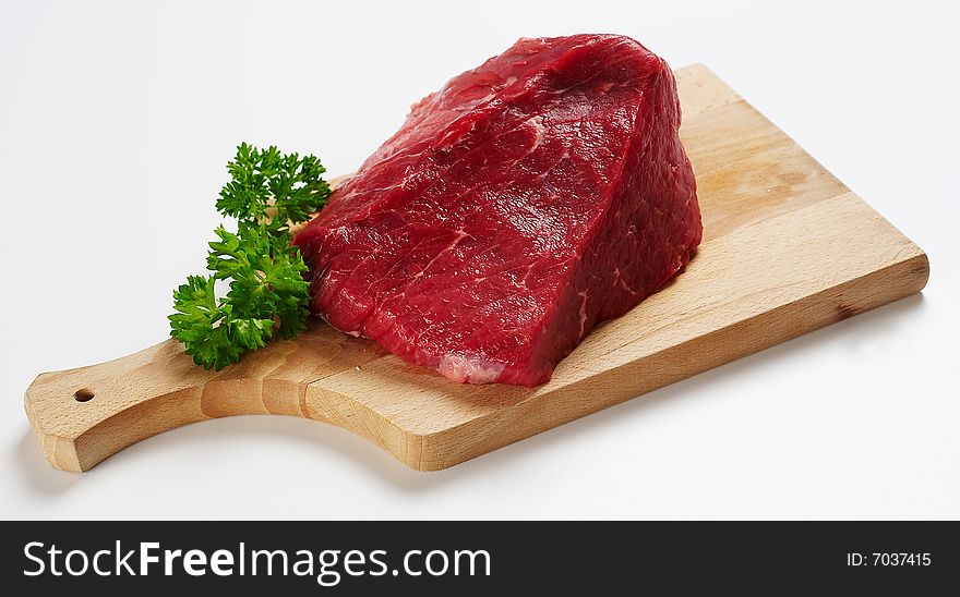 Piece of beef on wooden desk 1