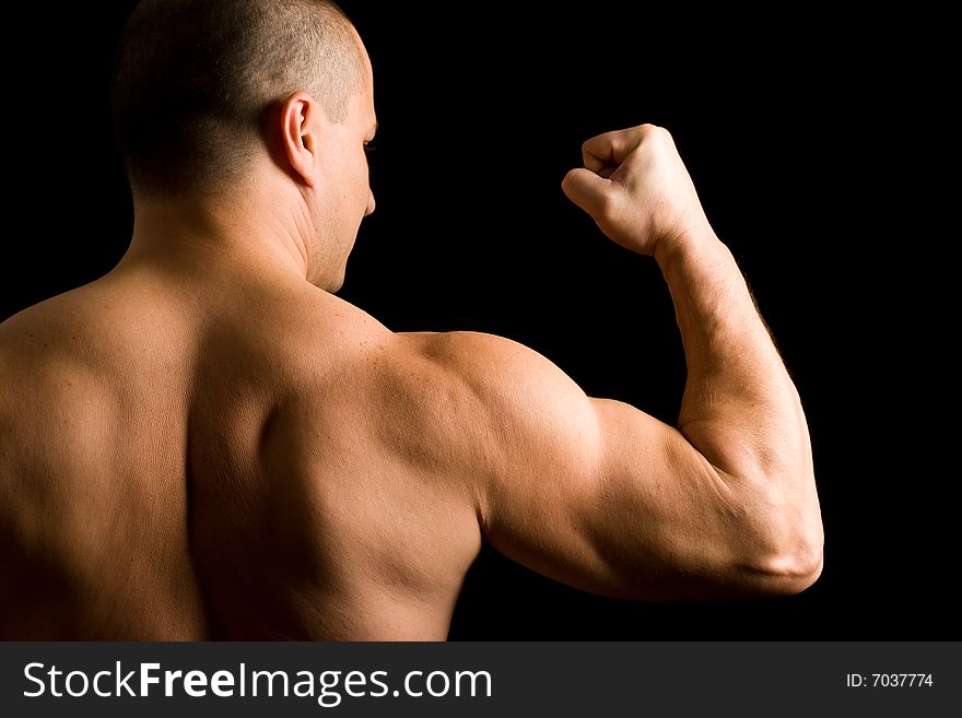 Young muscular man flexing his arm