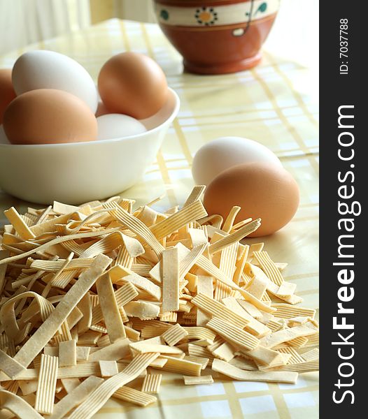 Egg noodles on a table and eggs closeup