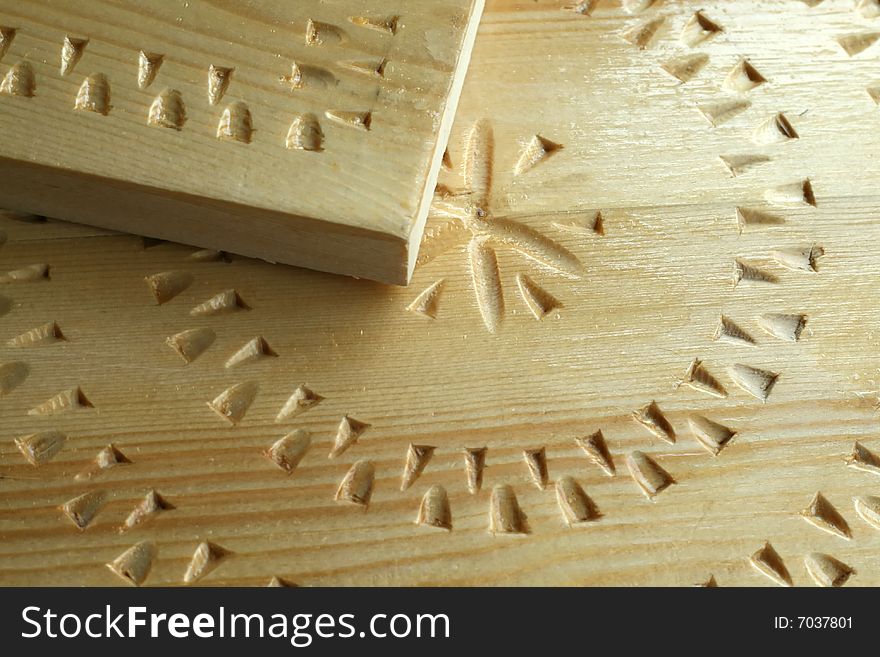 Woodcarving handwork,  light board  with a varnish covering, closeup