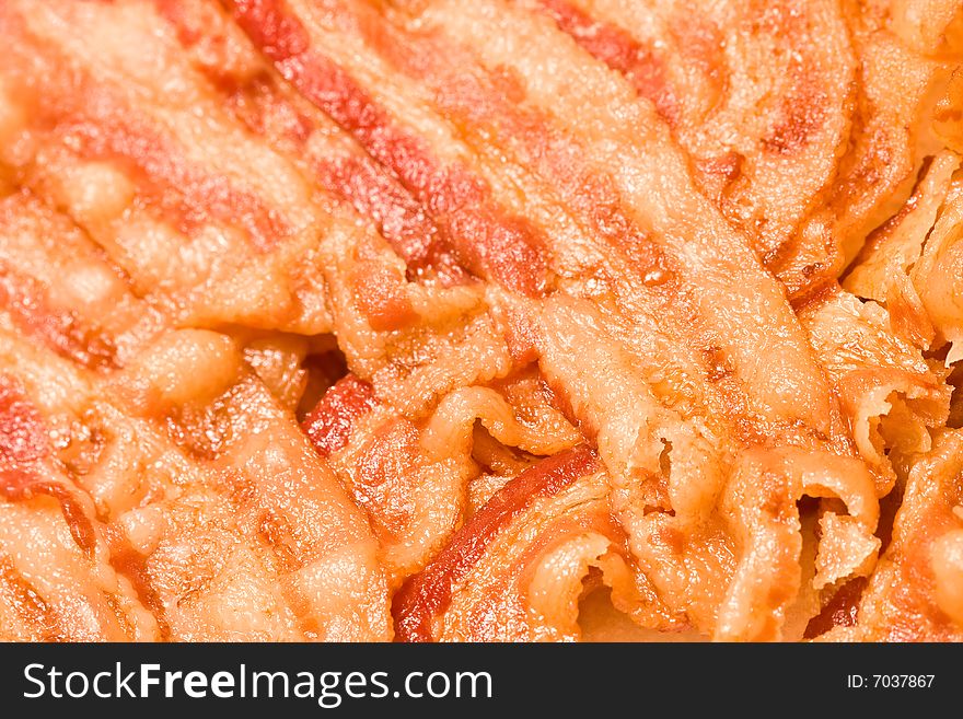 Close up of cooked bacon fresh off the stove