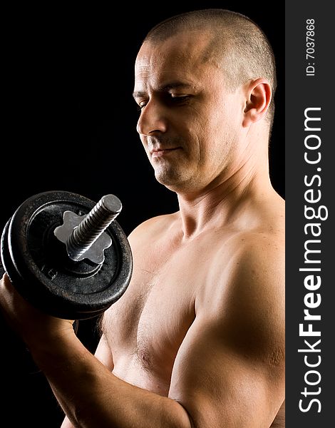 Man lifting weights isolated on black