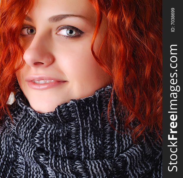 Portrait of a beautiful woman with red hair in a sweater. Portrait of a beautiful woman with red hair in a sweater