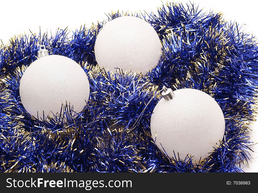 Three Christmas spheres and tinsel. Three Christmas spheres and tinsel